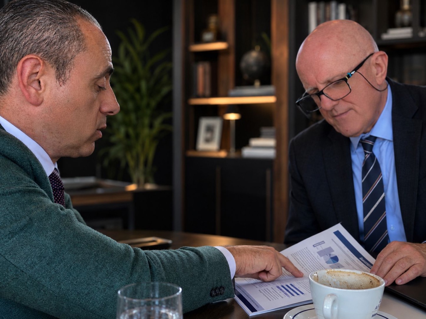 Paul Jannece reviewing business documents in a meeting