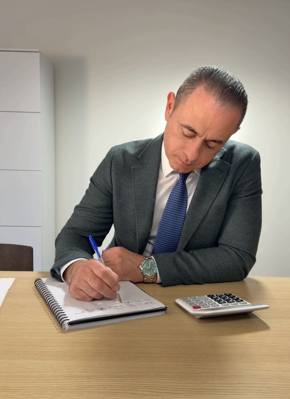 Paul Jannece writing at a desk